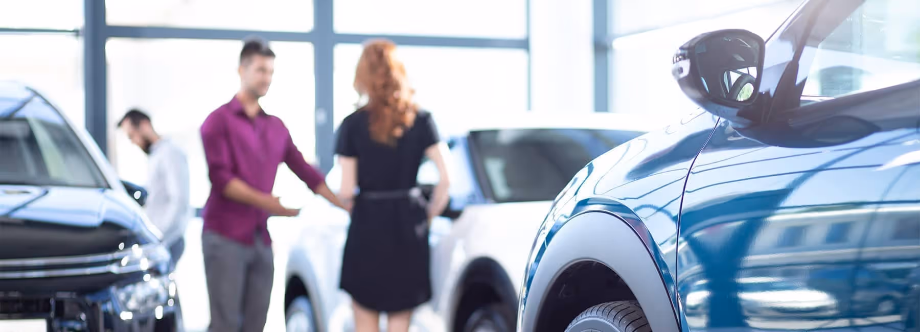 Customers-review-vehicles-in-a-new-car-showroom